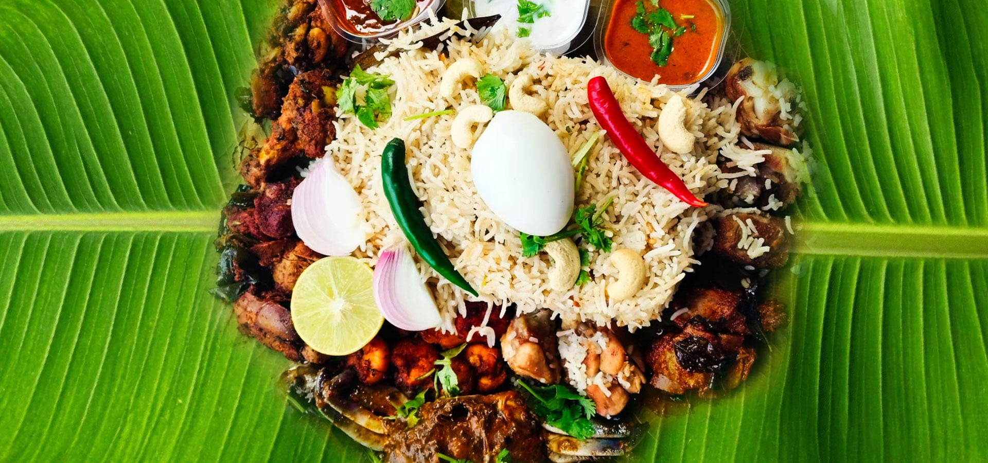 Chittibabu Kodi Pulav Andhra chicken rice served with boiled egg, spicy chicken fry, chutney and drink in a restaurant ambience with fire backgr
