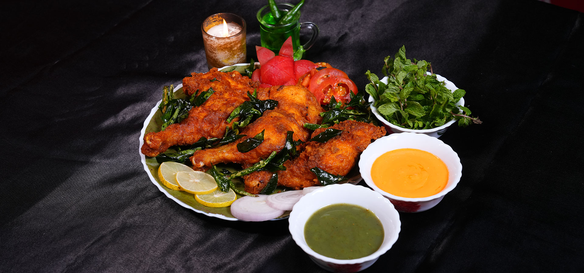 Chittibabu Kodi Pulav Andhra chicken rice served with boiled egg, spicy chicken fry, chutney and drink in a restaurant ambience with fire backgr